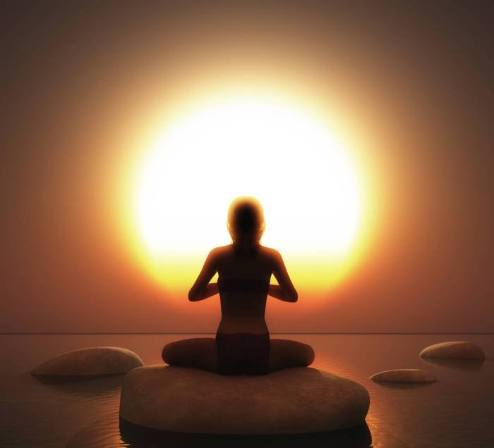 3D render of a female in yoga pose on rock in ocean against a sunset sky